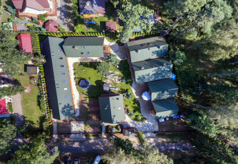 Aerial view of Holiday complex Pobierowo-Doppelhaus 4 and 2, green rooftops, gardens, and trees nearby.
