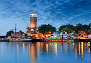 Evening view of marina with illuminated lighthouse and boats at Holiday home for 6 people Kołobrzeg.