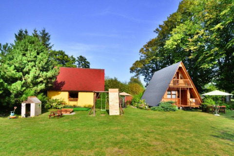 Summer cottage 70 m2 TYPE B Osieki in Denmark featuring A-frame wooden cabin, yellow house and garden.