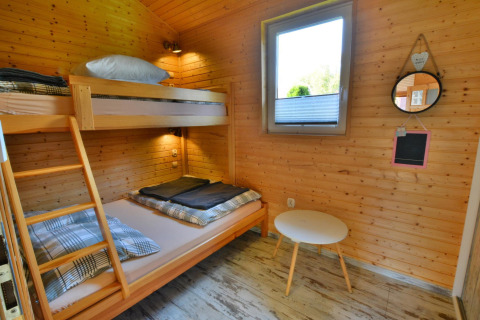 Room in Older year-round cottage TYPE A Ustronie Morskie with bunk bed, window, and small table, Denmark.
