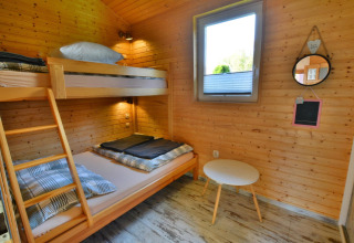 Room in Older year-round cottage TYPE A Ustronie Morskie with bunk bed, window, and small table, Denmark.