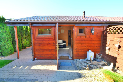Houten hut met open deur en betegeld terras bij Older year-round cottage TYPE A Ustronie Morskie.