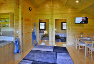 Interior view of summer cottage for 5 people with wooden decor in Ustronie Morskie, Denmark.