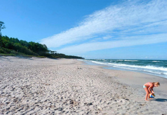 Photo d'une plage de sable près de Domki letniskowe Rusinowo, fille jouant avec un ballon au bord de la mer.