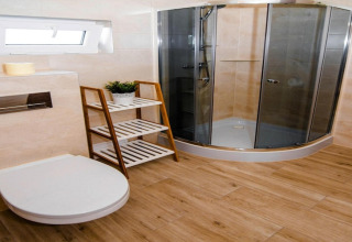 Moderne badkamer in Ustecka Osada 45m2, Denemarken, met douche, houten vloer, toilet en rek.
