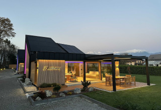 Evening view of Elegant Warm Bliss Hideaway Escape Lodge in Slovenia with cozy terrace and garden.