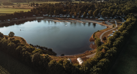 Aerial view of the water lodge at Recreation park De Achterste Hoef in the Netherlands, beside a lake.