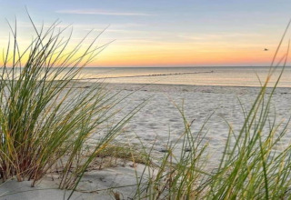 Zonsondergang en zeezicht vanaf het strand bij Houseboat «in Peenemünde» in Duitsland.