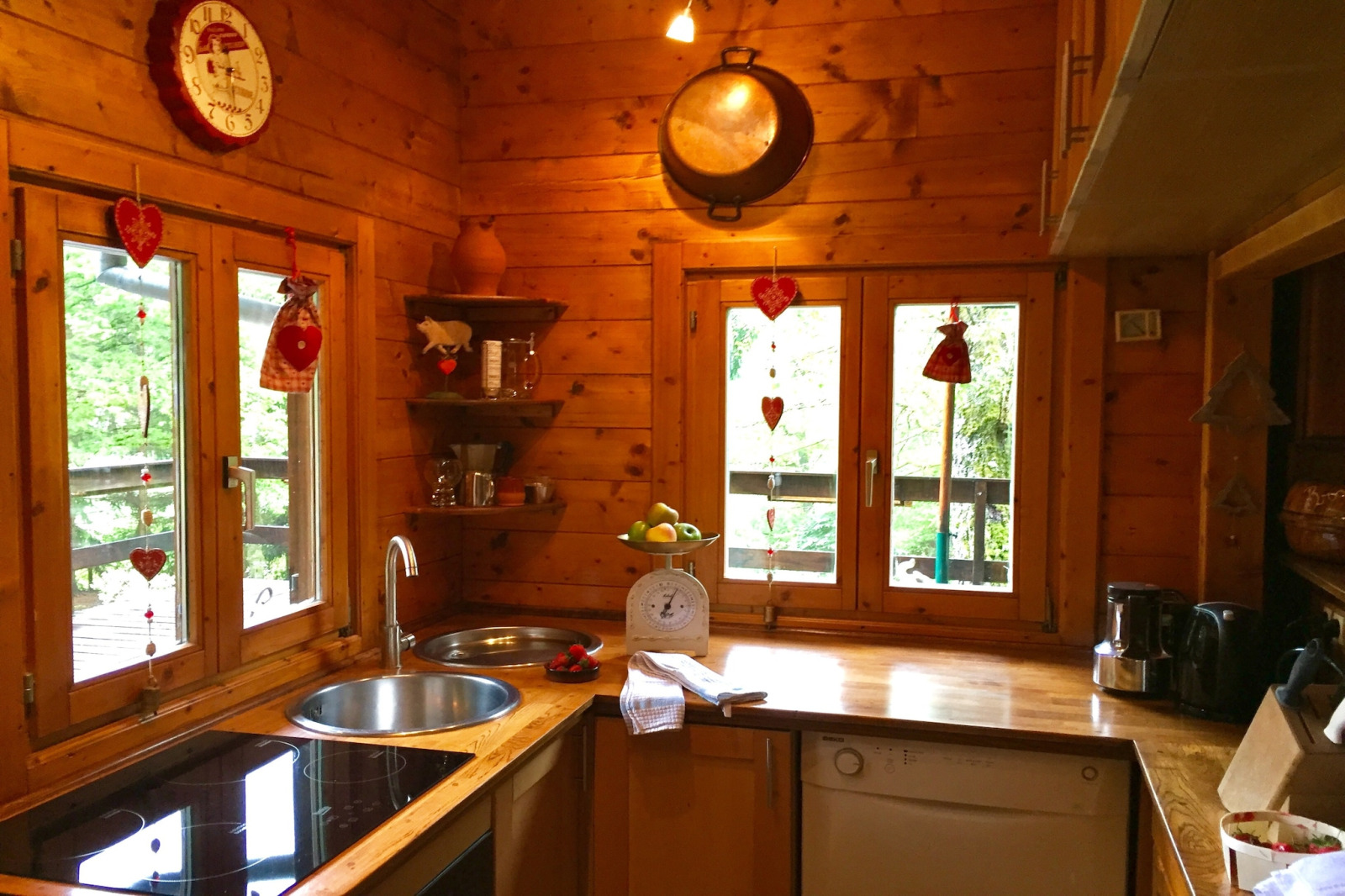 Gezellige houten keuken met hartdecoraties in chalet Remschweiler, Frankrijk, veel daglicht.