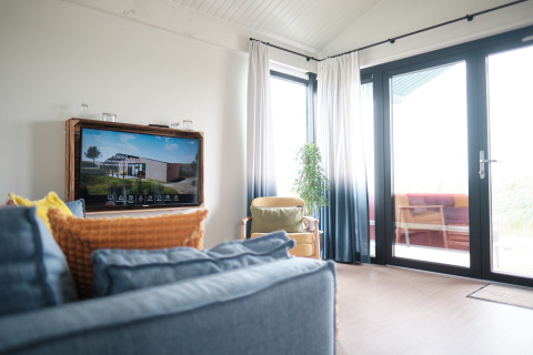 Bright living area at Resort Callantsoog 1 in the Netherlands, featuring large windows and modern decor.