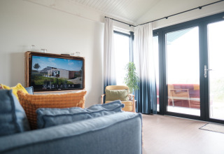 Bright living area at Resort Callantsoog 1 in the Netherlands, featuring large windows and modern decor.