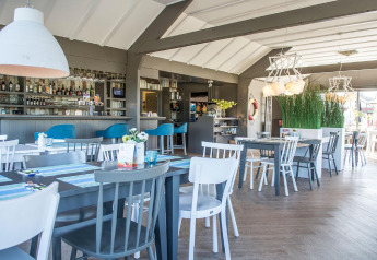 Modern dining area inside Holiday Park Loodsmansduin 1, Netherlands, with stylish decor and contemporary furniture.