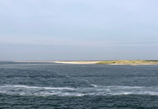 Vue sur la mer et la côte depuis Holiday Park «Loodsmansduin 1» aux Pays-Bas sous un ciel nuageux.