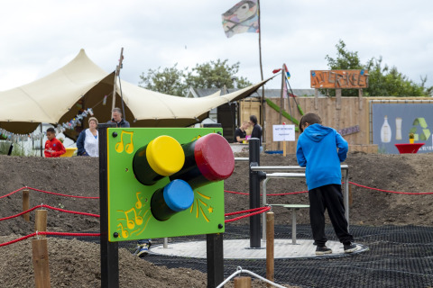 Children playing near colorful interactive installation at Beach Park Vlugtenburg 13 in the Netherlands.