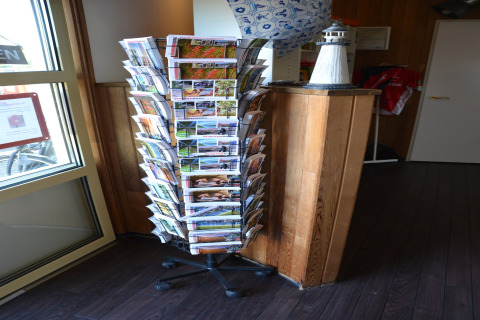 Rotating brochure stand in a safari tent lobby at Beach Park Vlugtenburg 13 in the Netherlands.