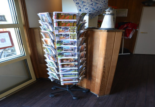 Rotating brochure stand in a safari tent lobby at Beach Park Vlugtenburg 13 in the Netherlands.