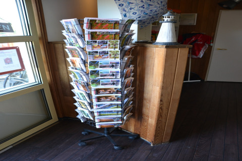 Rotating postcard stand in the corner of Beach Park Vlugtenburg 12 safari tent, Netherlands.