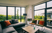 Bright living room with large windows and garden view at Holiday Park Zeedijk 3, Netherlands, modern decor.