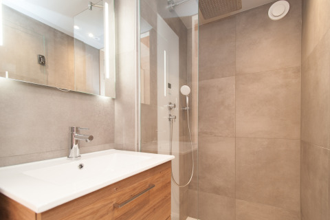 Salle de bain moderne avec douche et meuble en bois d'une tiny house à l'Eco Resort Grevelingenstrand, Pays-Bas.