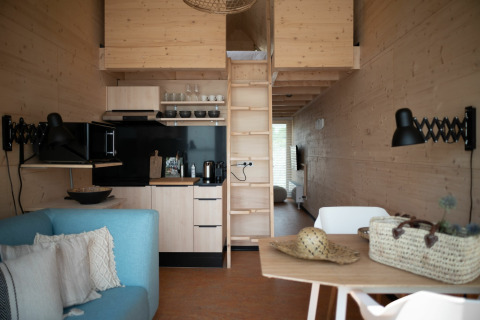 Intérieur d'une tiny house à l’Eco Resort Grevelingenstrand aux Pays-Bas, avec un décor moderne en bois.