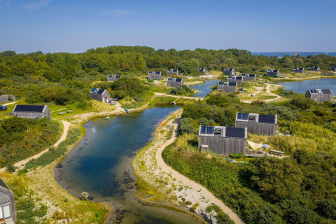 Vue aérienne des petites maisons d’Eco Resort Grevelingenstrand entourées d’eau et de verdure aux Pays-Bas.