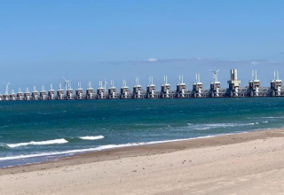 View of the sea and impressive storm surge barrier as seen from the beach at tiny house 'Noordzee' in NL.