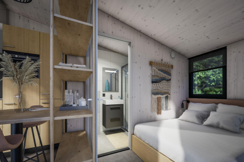 Interior moderno de tiny house en Holiday Park Klein Vink 23, Países Bajos, con dormitorio, baño y cocina.