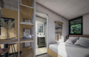 Modern tiny house interior at Holiday Park Klein Vink 23 in the Netherlands, showing bedroom, bath, and kitchen.