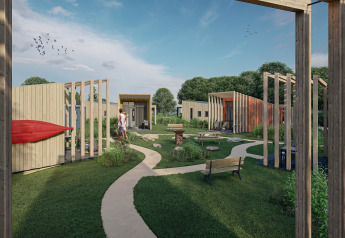 Outdoor area with tiny wooden houses, winding paths and greenery at Holiday Park Klein Vink 23, Netherlands.