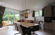 Modern living and kitchen area in a lodge at Holiday Park De Rimboe & De Woeste Hoogte 25 in the Netherlands