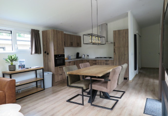 Modern kitchen and dining area in a lodge at Holiday Park De Rimboe & De Woeste Hoogte, Netherlands.