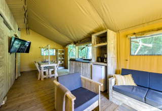 Modern safari tent cabin at Country Estate Gerner 8 in the Netherlands, featuring cozy wooden furniture.