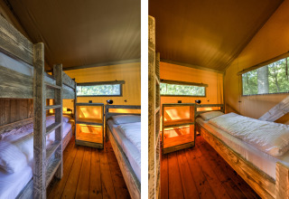 Sleeping area in a safari tent at Country Estate Gerner 8 in the Netherlands, featuring bunk beds and wood décor.