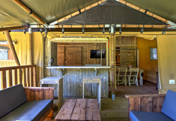 Interior view of a safari tent at Country Estate Gerner 8 in the Netherlands with rustic wood furniture.