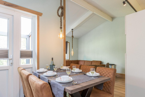 Eettafel met chique servies en leren stoelen bij lodge Residence De Eese 3 in Nederland.