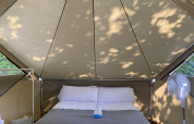 Innenansicht eines Bell Tent im Wecamp Cudillero, Spanien, mit Doppelbett und Ventilator.