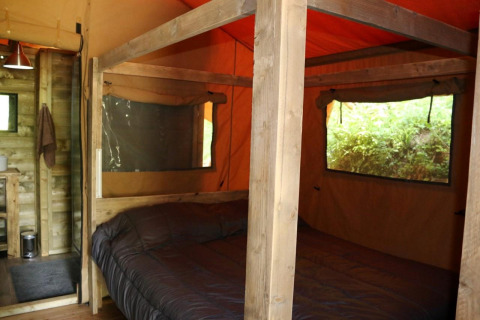 Vista interna della tenda Safari Lodge XL al campeggio Moulin de Chaules in Francia, letto matrimoniale.