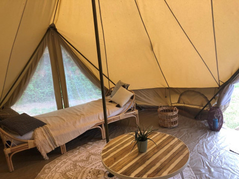 Interior of a spacious safari tent, Emperor Bell Tent, at Campsite Moulin de Chaules in France.