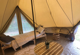 Interior of a spacious safari tent, Emperor Bell Tent, at Campsite Moulin de Chaules in France.