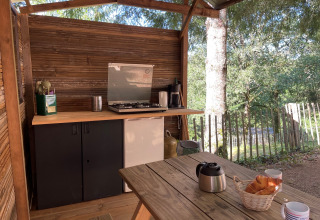 Outdoor kitchen setup in the Emperor Bell Tent at Campsite Moulin de Chaules, France, with coffee and croissants.