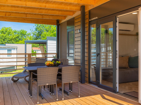 Covered terrace at Park Riviera «Adria Garden» in Campsite Park Umag, Croatia, featuring outdoor dining.