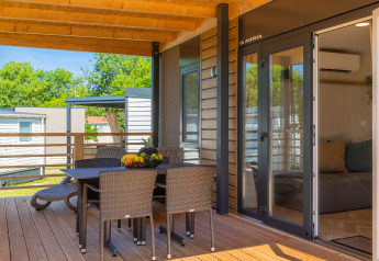 Covered terrace at Park Riviera «Adria Garden» in Campsite Park Umag, Croatia, featuring outdoor dining.