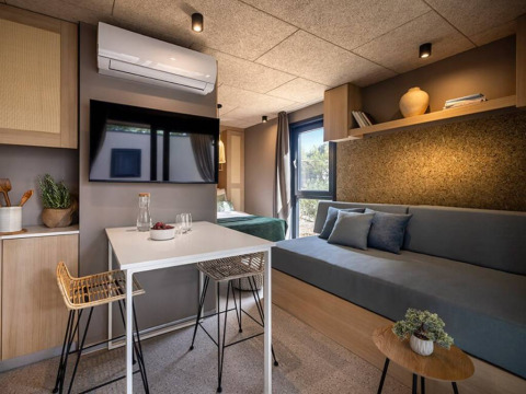 Modern interior of Hilltop Green Chalet at Valamar Camping Padova in Croatia featuring living and dining areas.