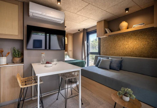 Modern interior of Hilltop Green Chalet at Valamar Camping Padova in Croatia featuring living and dining areas.