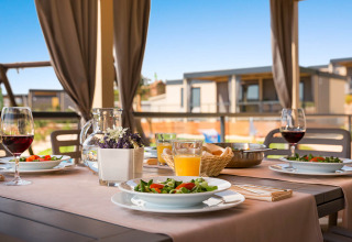 Buitendiner bij Bella Vista Home, Valamar Camping Krk, Kroatië, gedekt met wijn, salade en sap.
