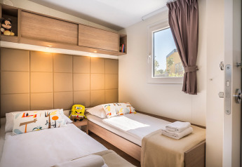 Dormitorio con dos camas individuales, decoración moderna, juguetes y ventana en Bella Vista Home Garden terrace.