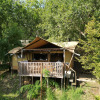 Safari tent accommodation at Centro Vacanze San Marino nestled among lush green trees in a tranquil setting.