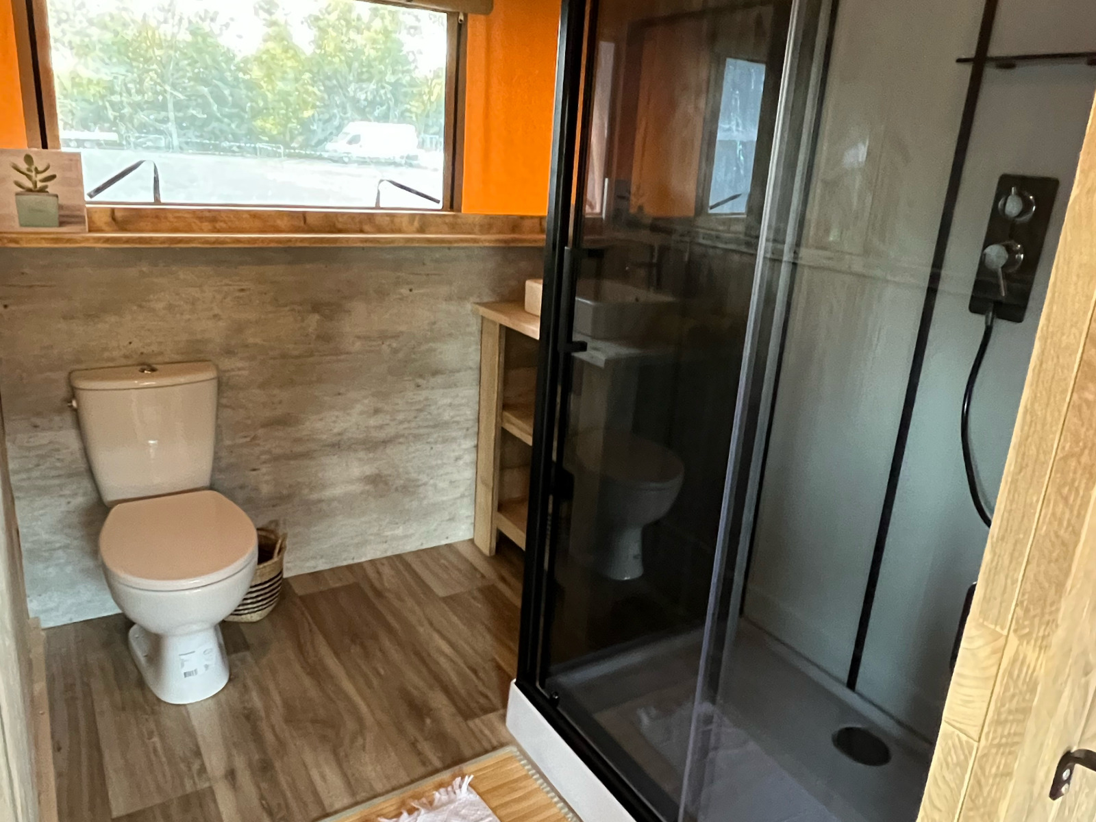 Badkamer met toilet en douche in een luxe safaritent op Camping Les Franquettes in Frankrijk.