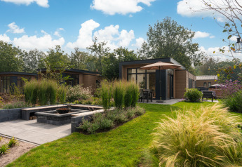 Modern ‘Cannenburch’ Deluxe lodge at Veluwe park de Bosgraaf in the Netherlands, garden and patio view.