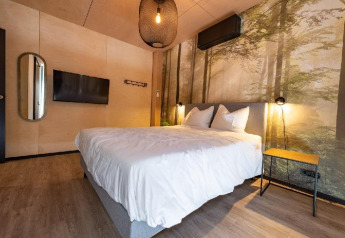 Chambre de Forest Villa à Holiday Park BreeBronne, Pays-Bas, avec mur forêt et déco moderne.